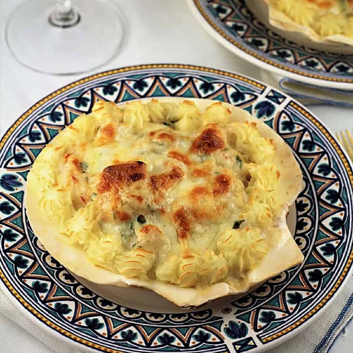 Coquilles St-Jacques, scallop shells filled with seafood in bechamel sauce.