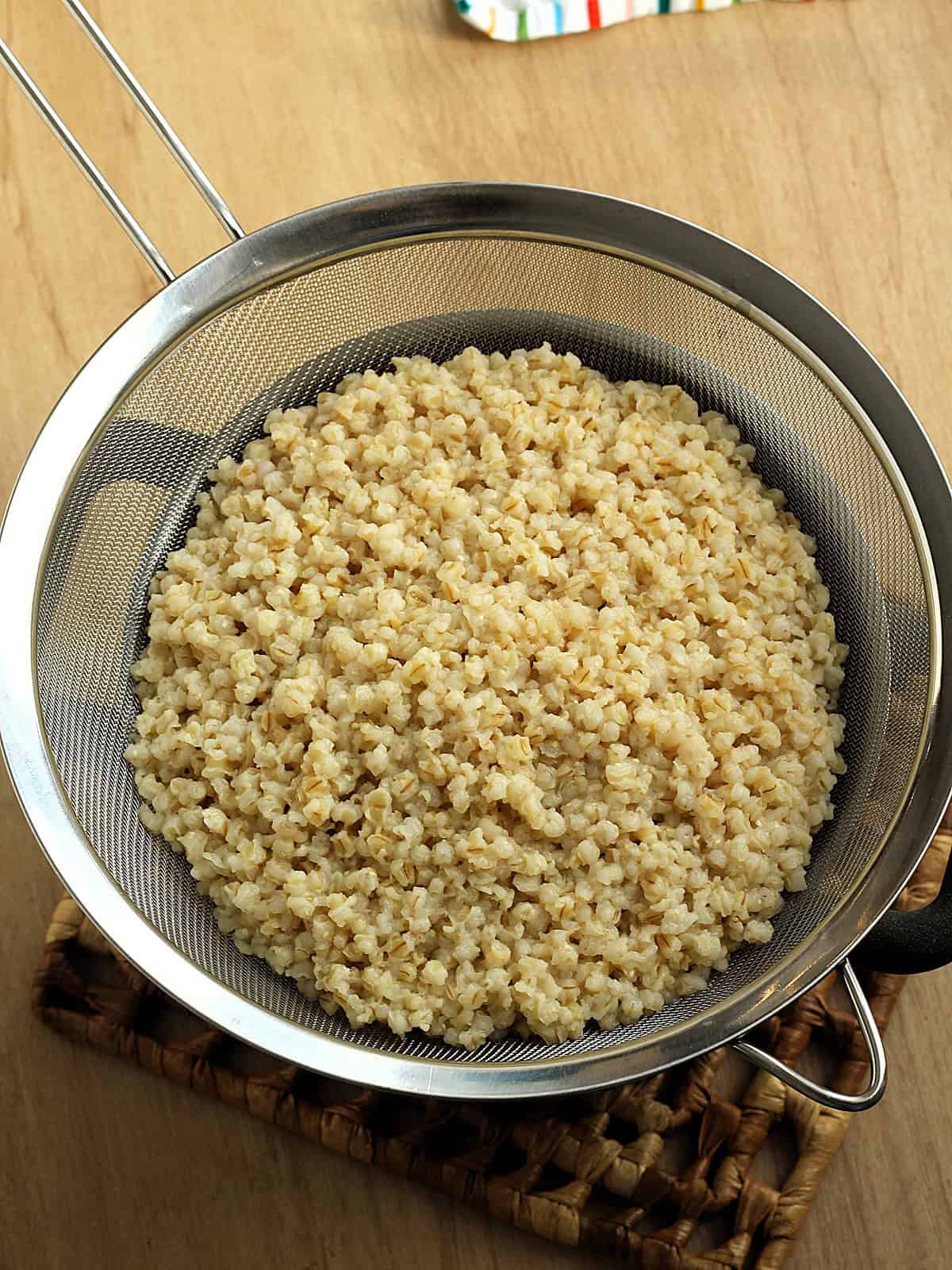 Cooked soft wheat berries drained in sieve for making cuccia.