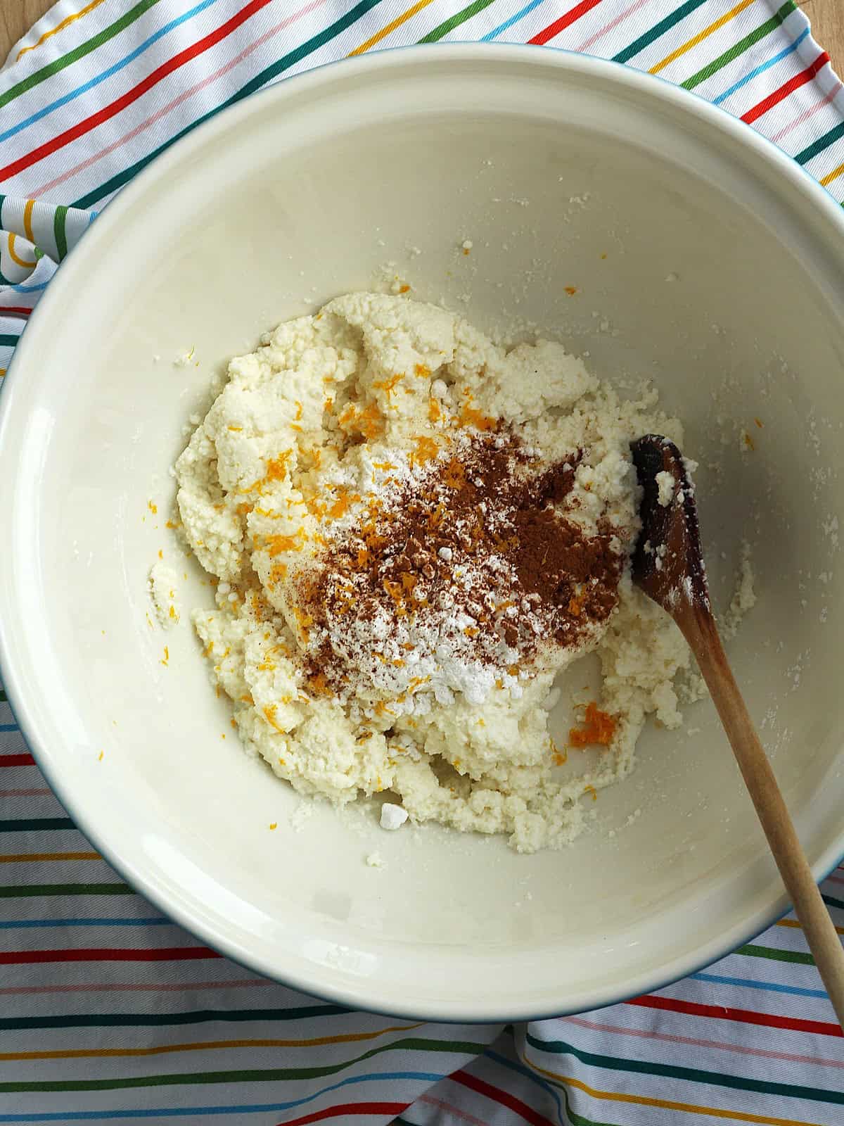 Ricotta combined with sugar, cinnamon and orange zest in large bowl for cuccia.