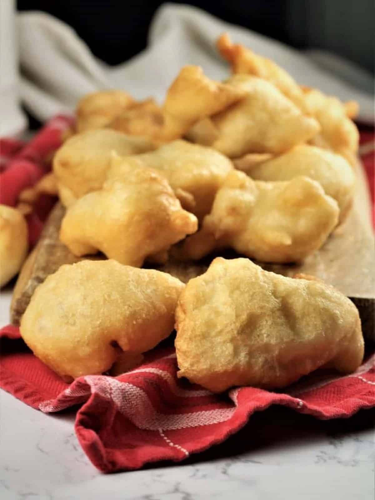 Just fried sfinci on wood board.