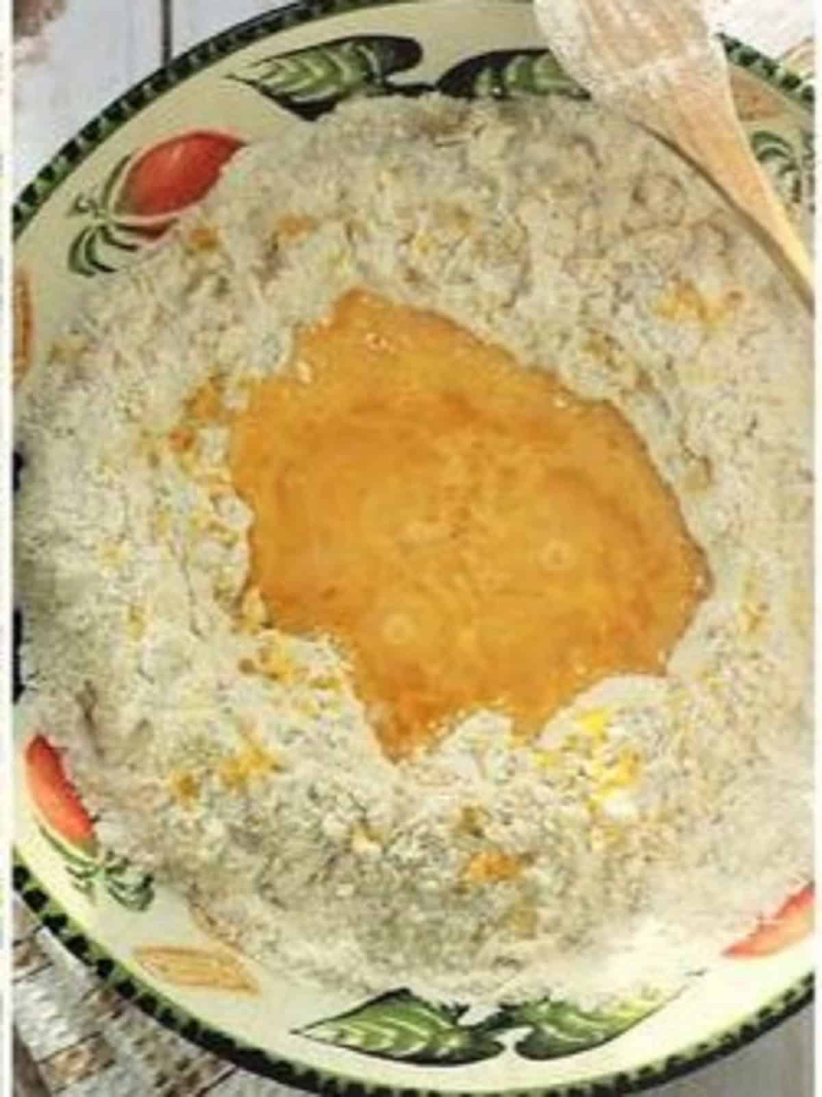 Eggs and grappa stirred into bowl with flour and butter. 