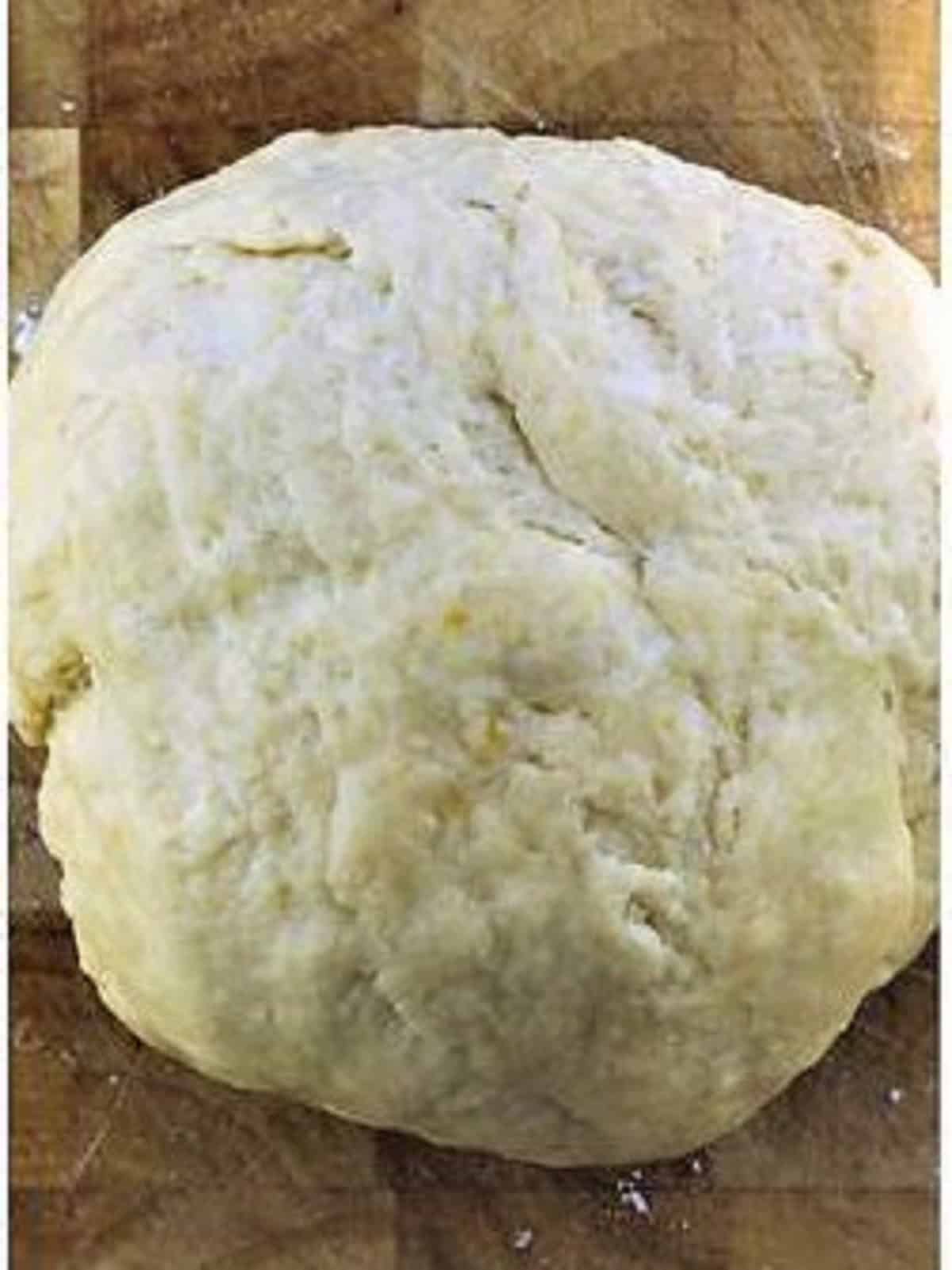 Chiacchiere dough on wood board.