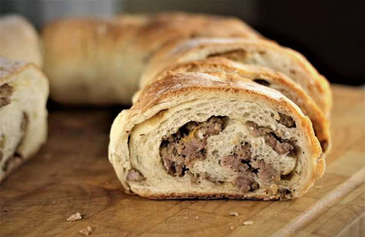 Sicilian sausage bread cut open to reveal sausage and onions.