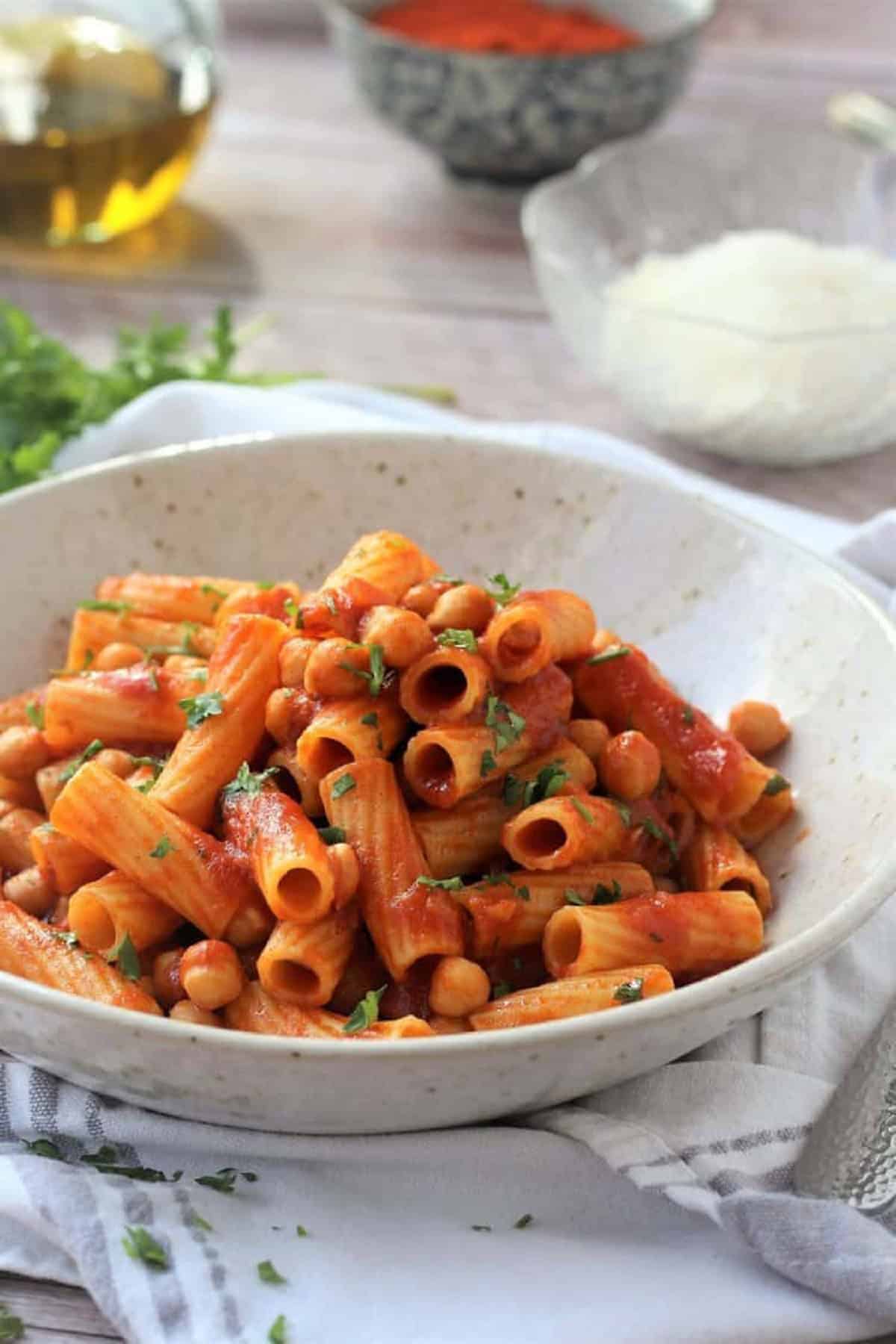 Bowl of pasta with chickpeas and tomato sauce.