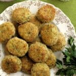 Cheesy baked potato broccoli meatballs on serving plate with sprig of parsley.