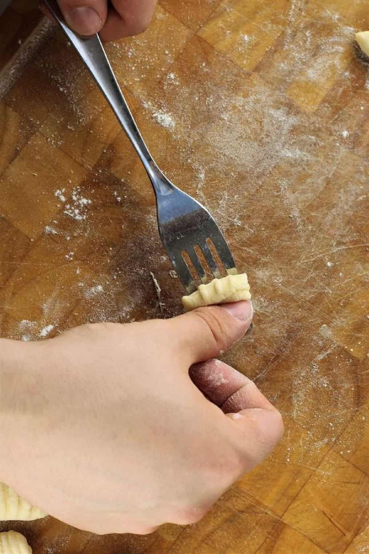 How to roll gnocchi on the tines of a fork.