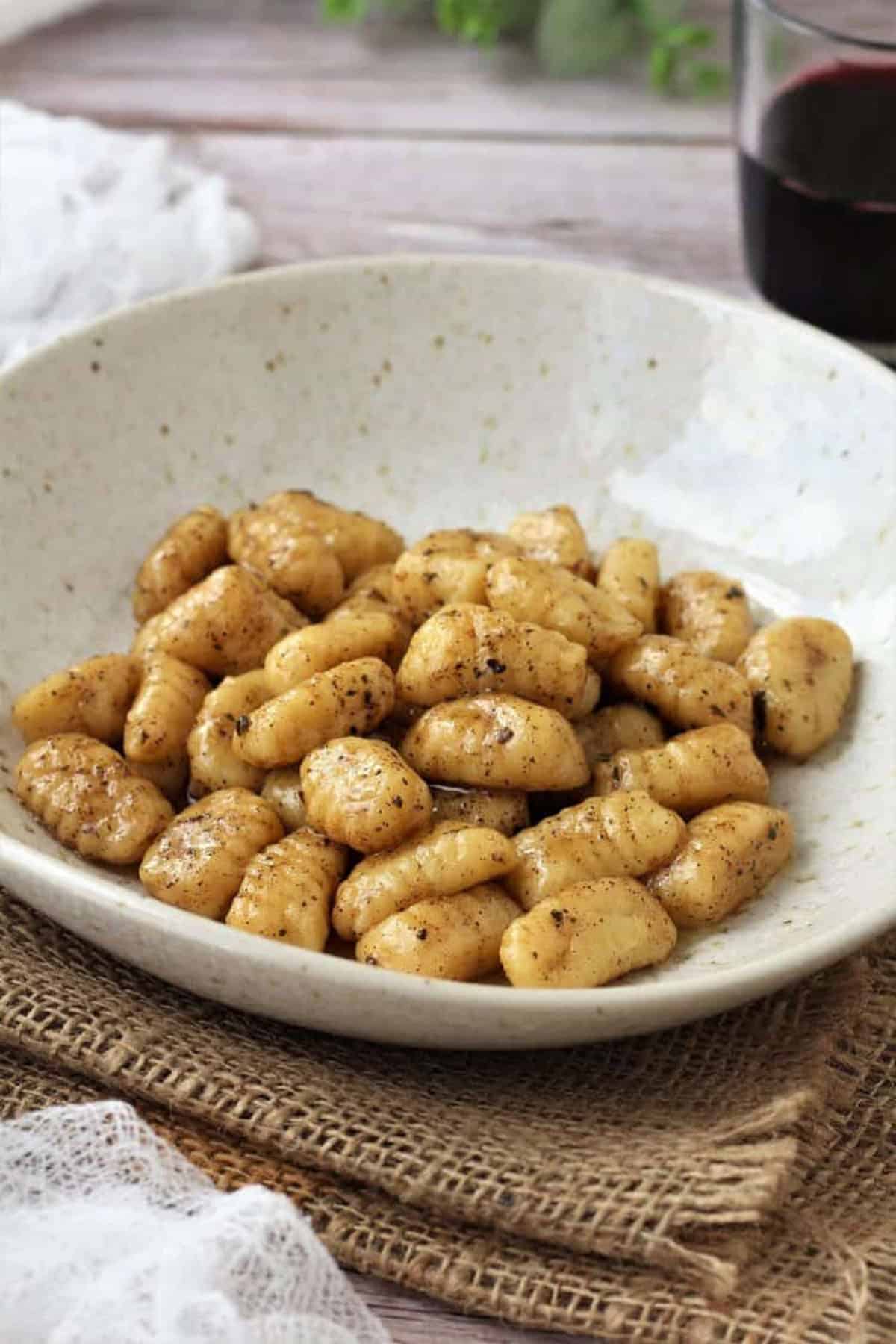 Ricotta gnocchi served with a butter sage sauce in bowl.