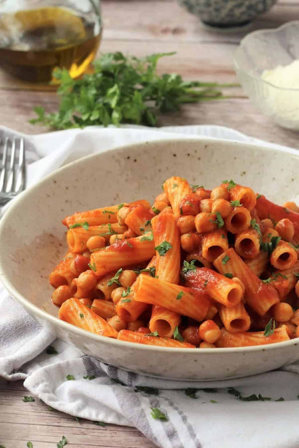 Bowl of pasta with chickpeas in tomato sauce.