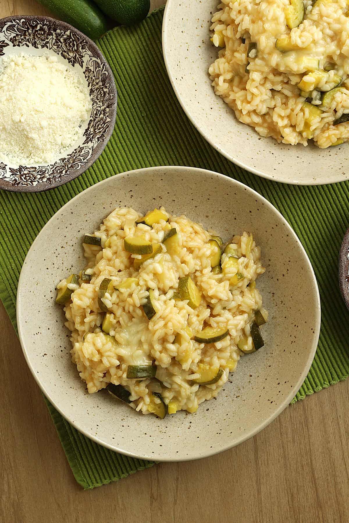 Bowls of creamy risotto with zucchini and scamorza cheese.