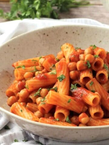Bowl of chickpea pasta with tomato sauce.