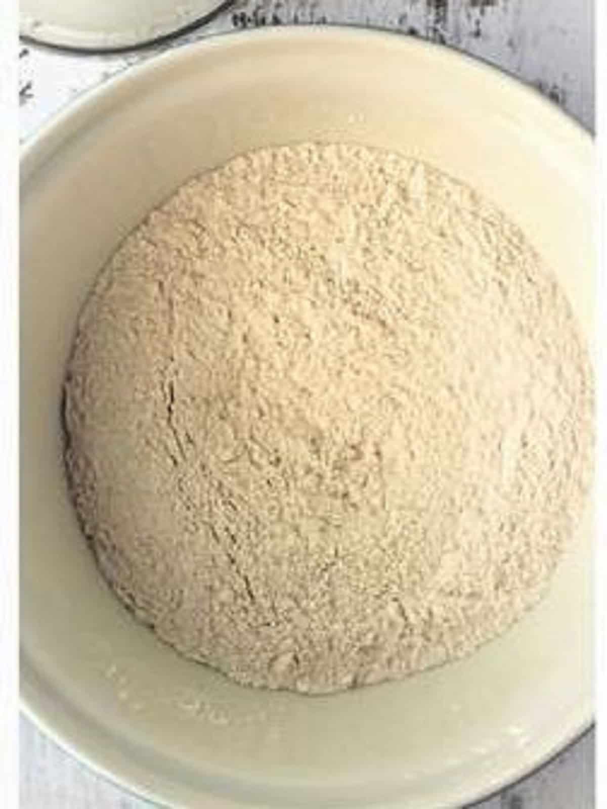 Flour and salt combined in bowl for sfincione recipe.