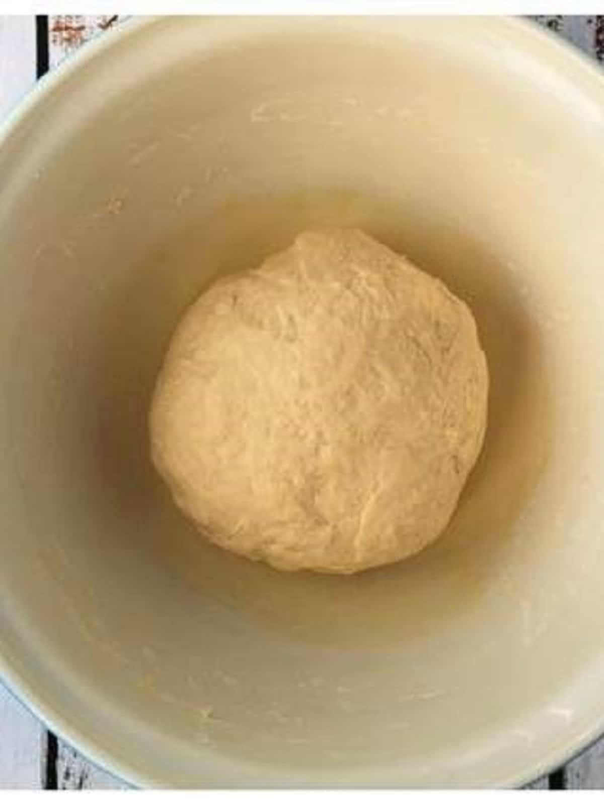 Dough for sfincione pizza in large bowl for proofing.