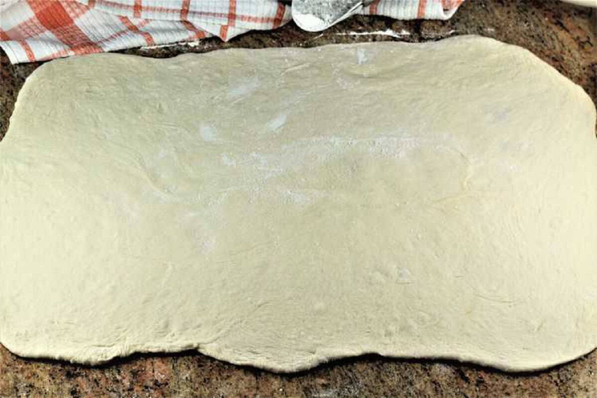 Flattened bignolati dough in large rectangular shape.