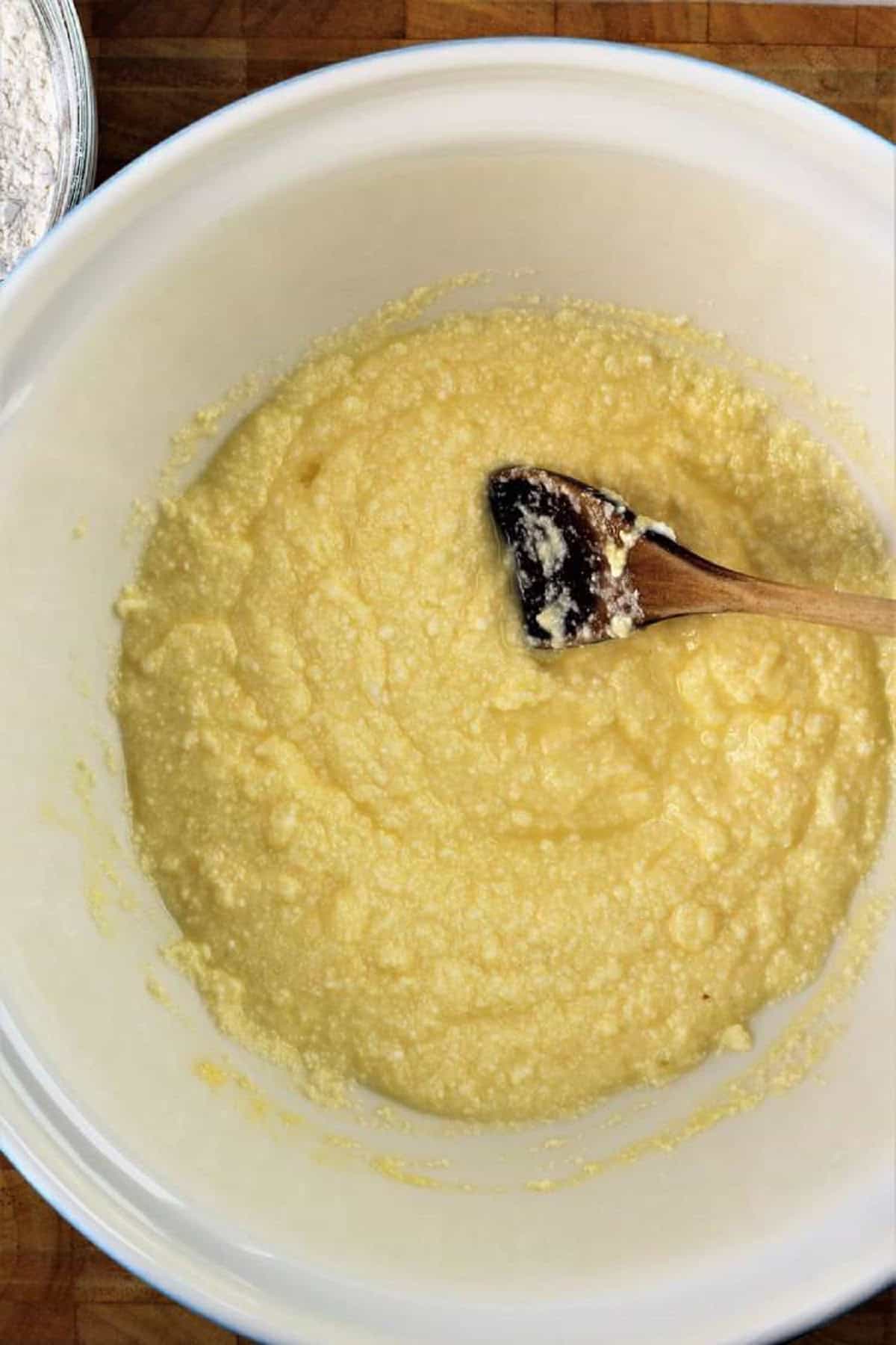 Ricotta and eggs stirred together in bowl for gnocchi with ricotta recipe