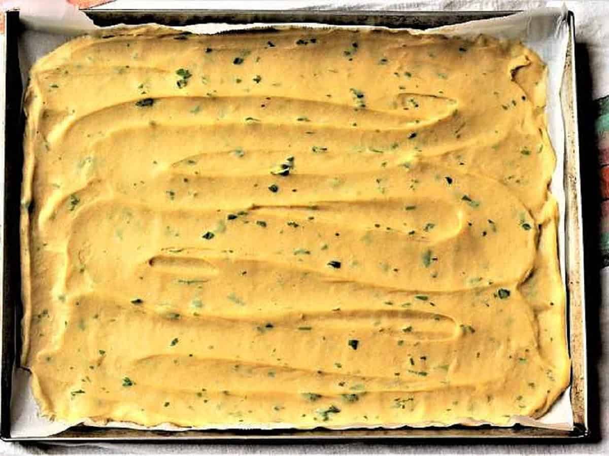 Panelle mixture spread out on baking sheet to cool.