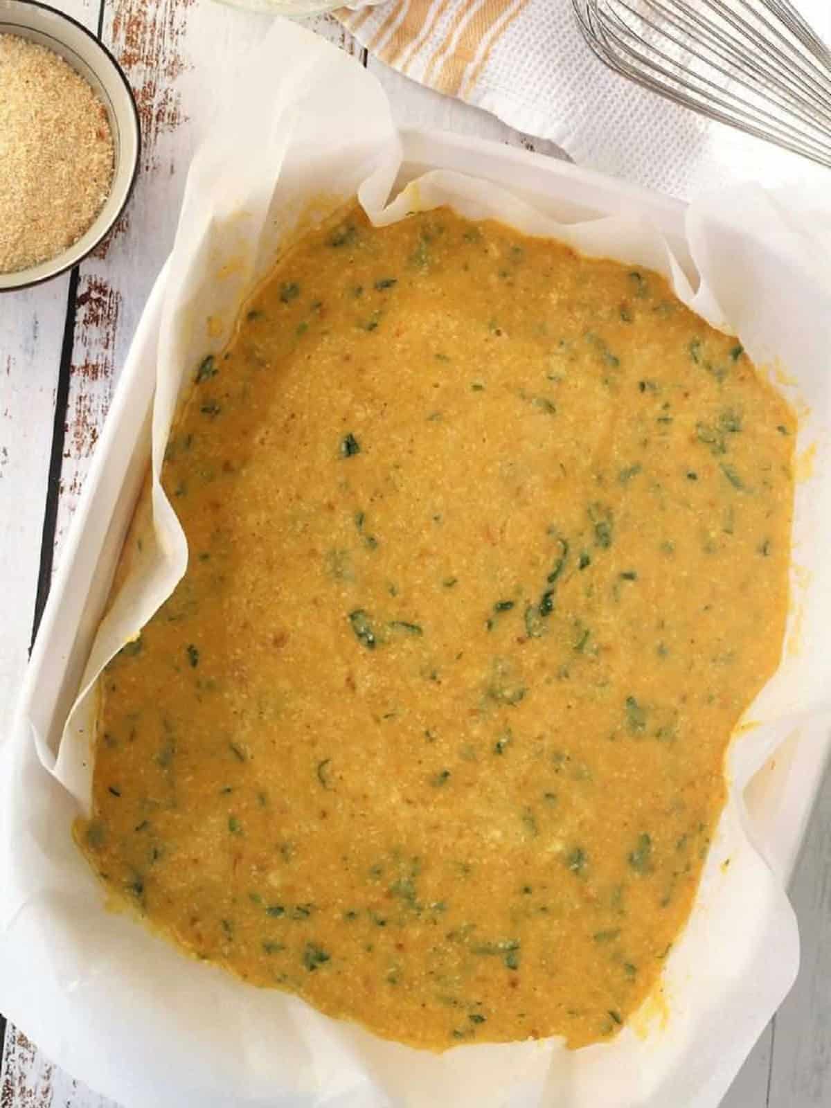 Zuppa imperiale egg batter spread out on baking sheet.