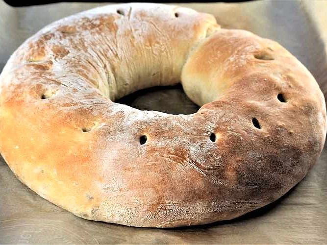 Baked sphere shaped Sicilian sausage bread.