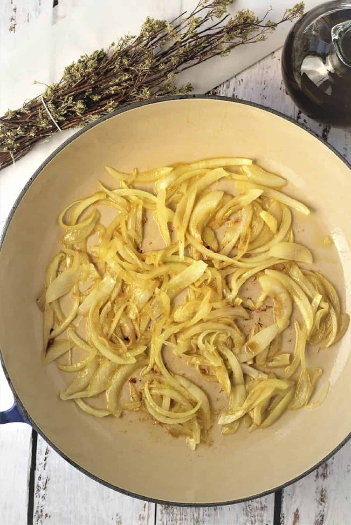 Sautéed sliced onion in olive oil for sfincione sauce.