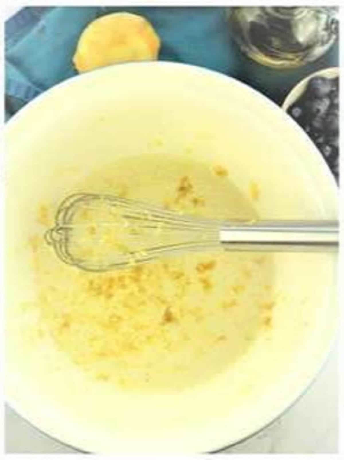 Lemon zest whisked in olive oil cake batter.