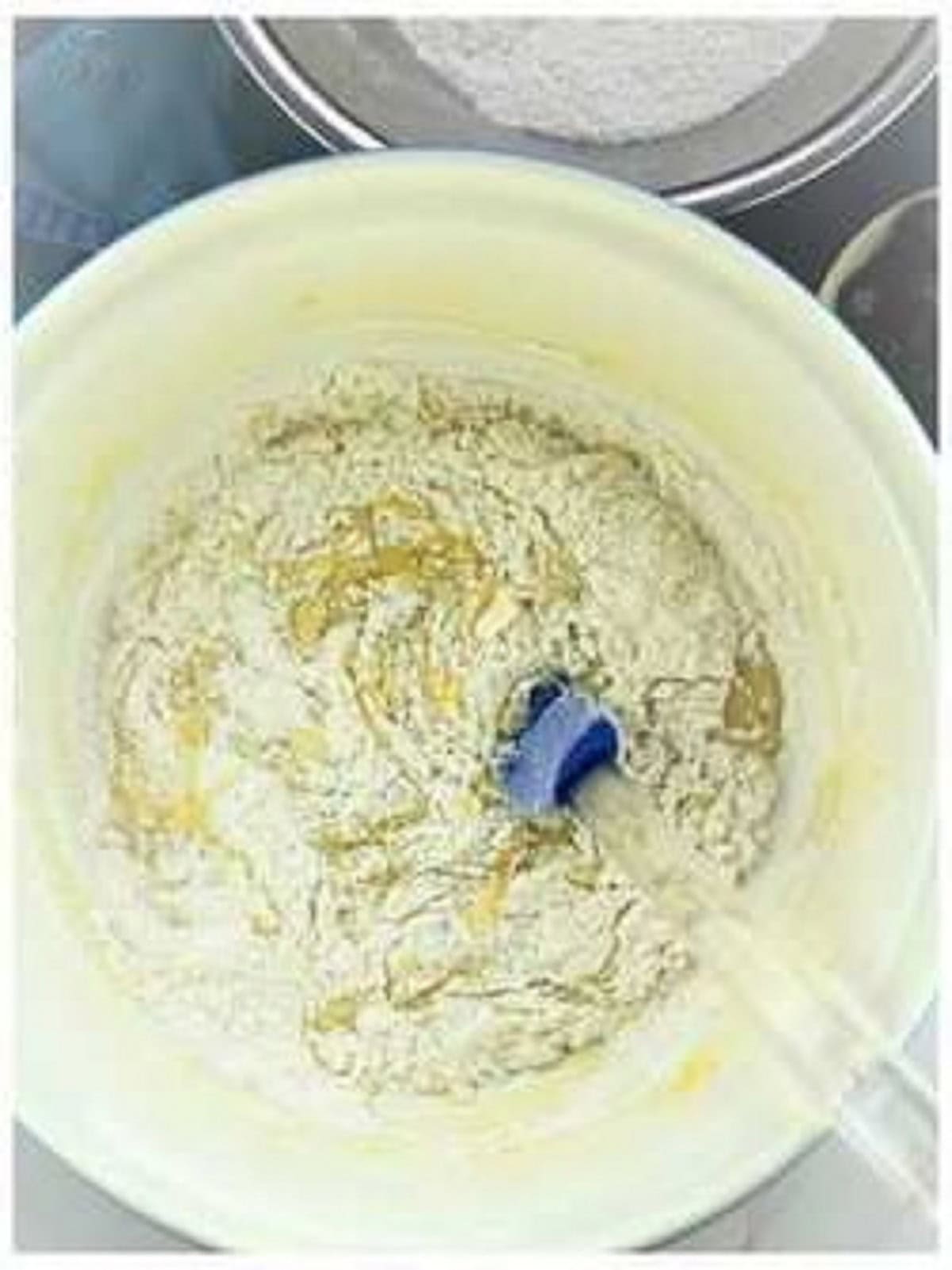 Flour stirred into olive oil cake batter.