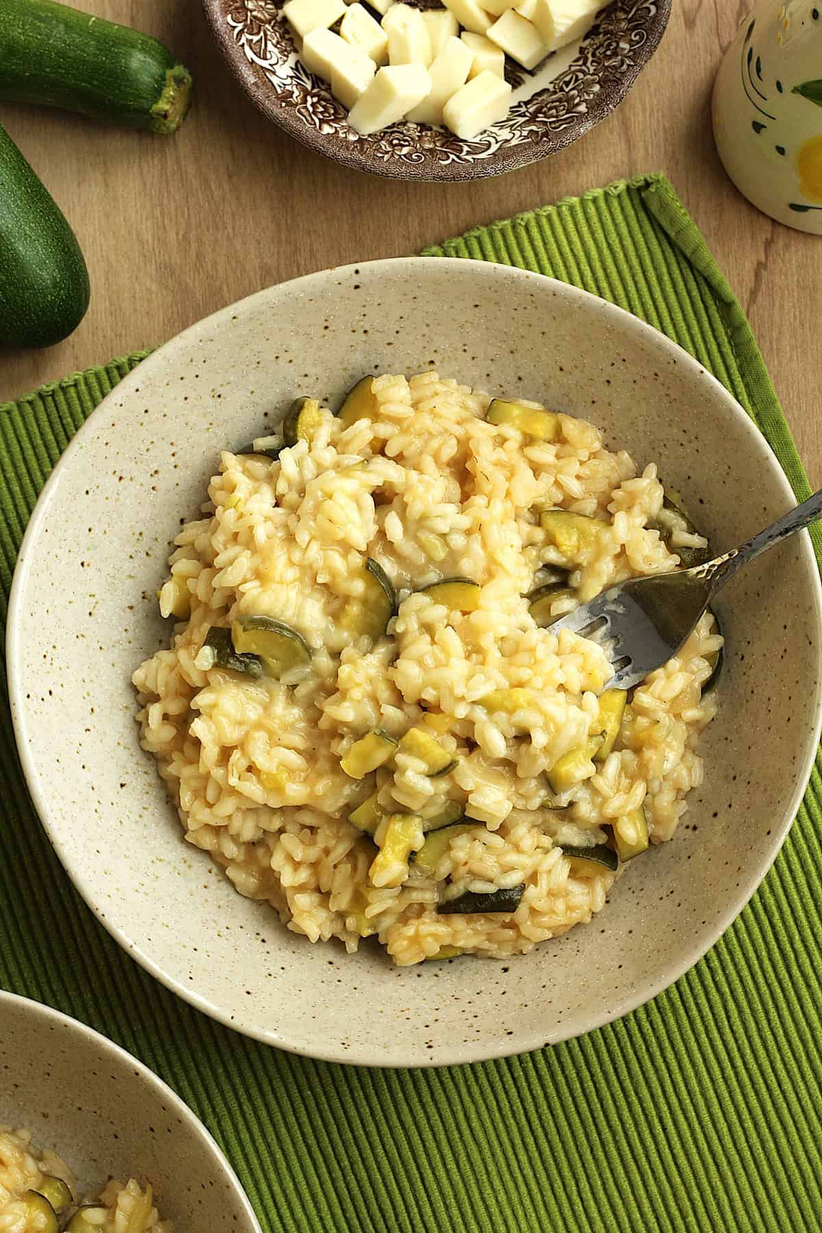 Bowl of zucchini risotto with fork in it.