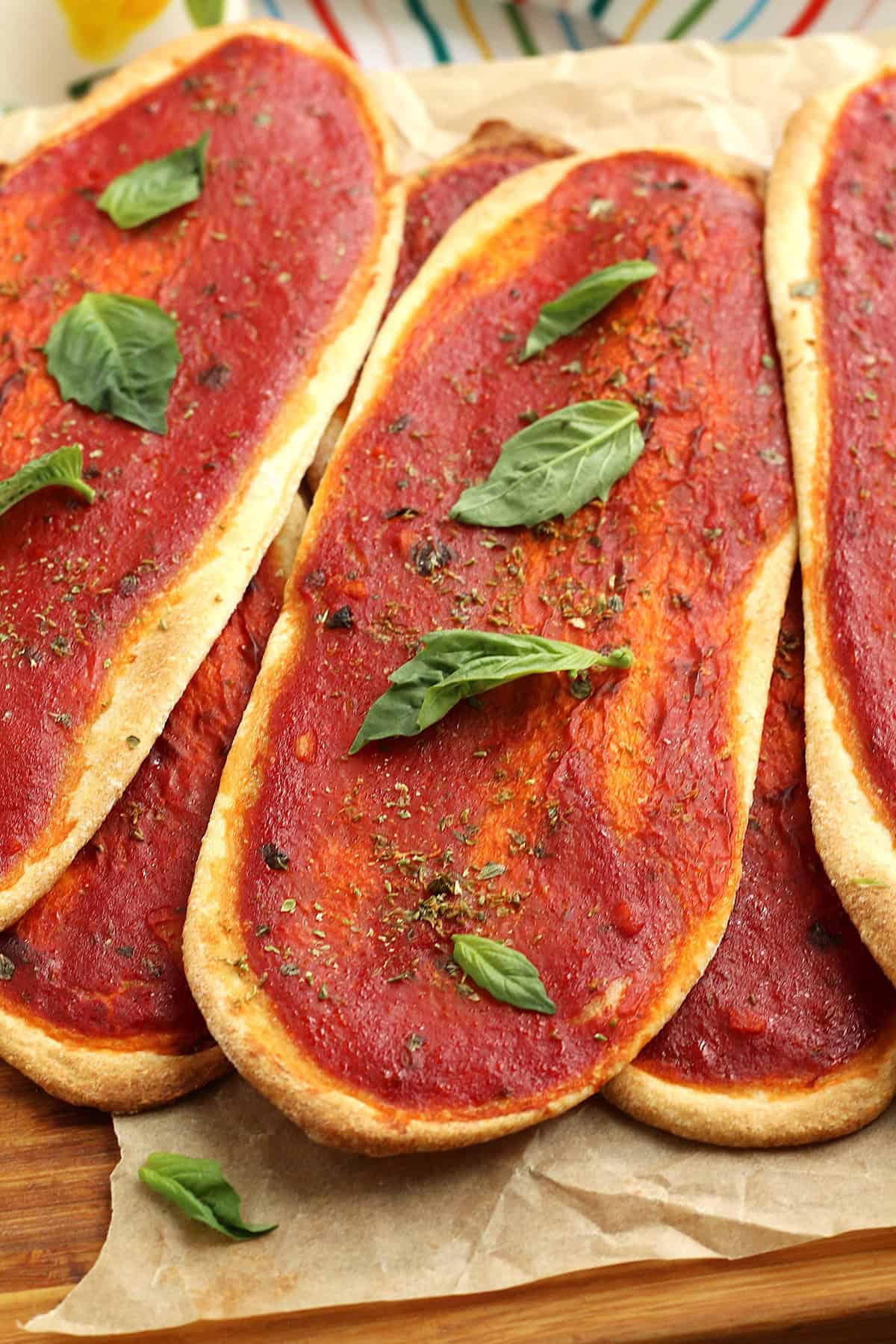 Crispy long pizza tongues covered with tomato sauce.