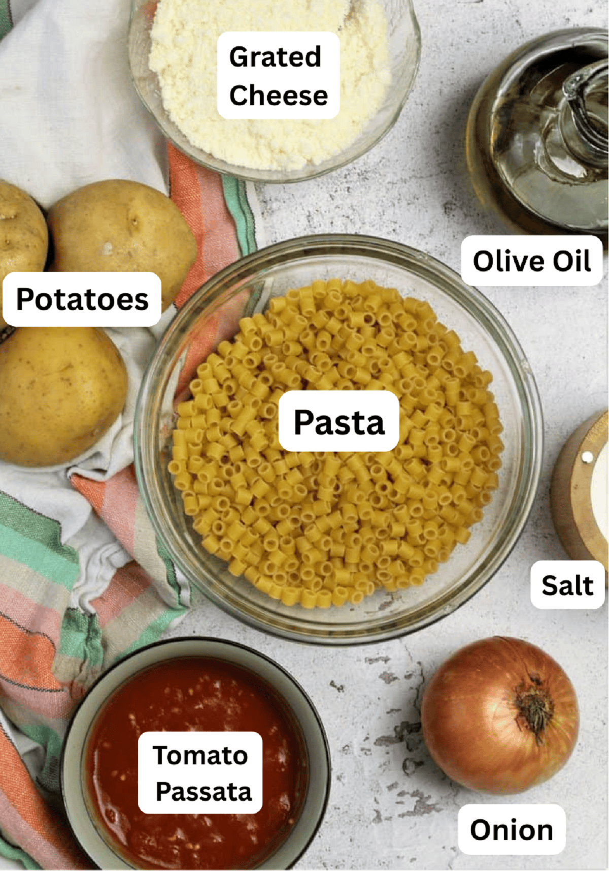 Pasta, potatoes, tomato purée, onion, salt, olive oil and grated cheese.
