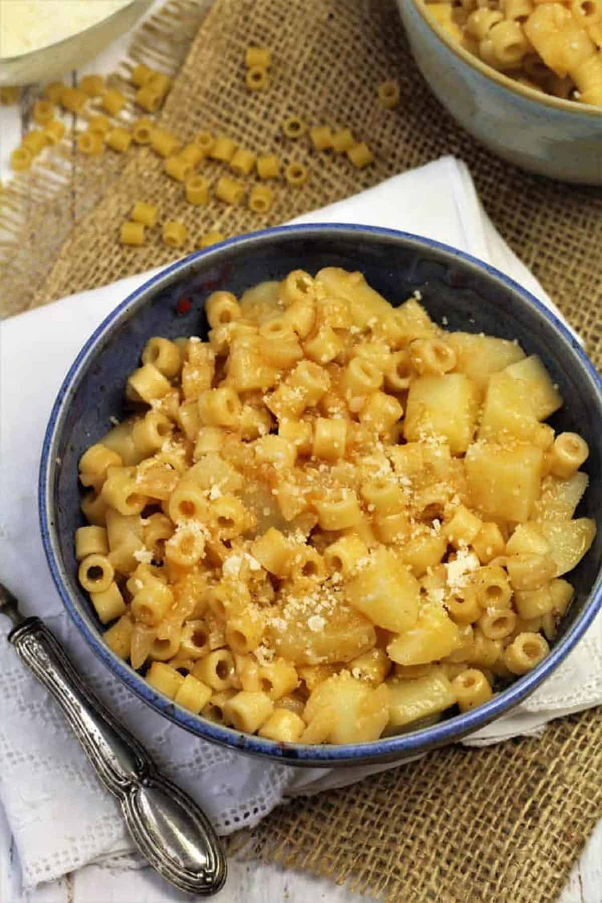 Pasta and potatoes soup in bowl.