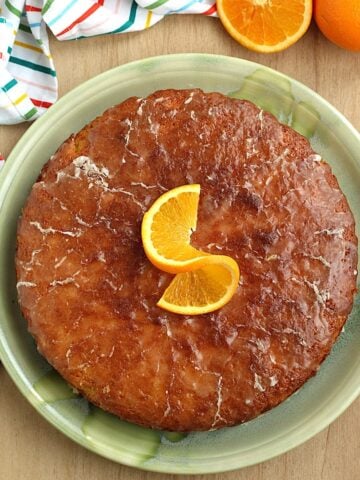 Pan d'arancio, Sicilian whole orange cake, on plate topped with orange slice.
