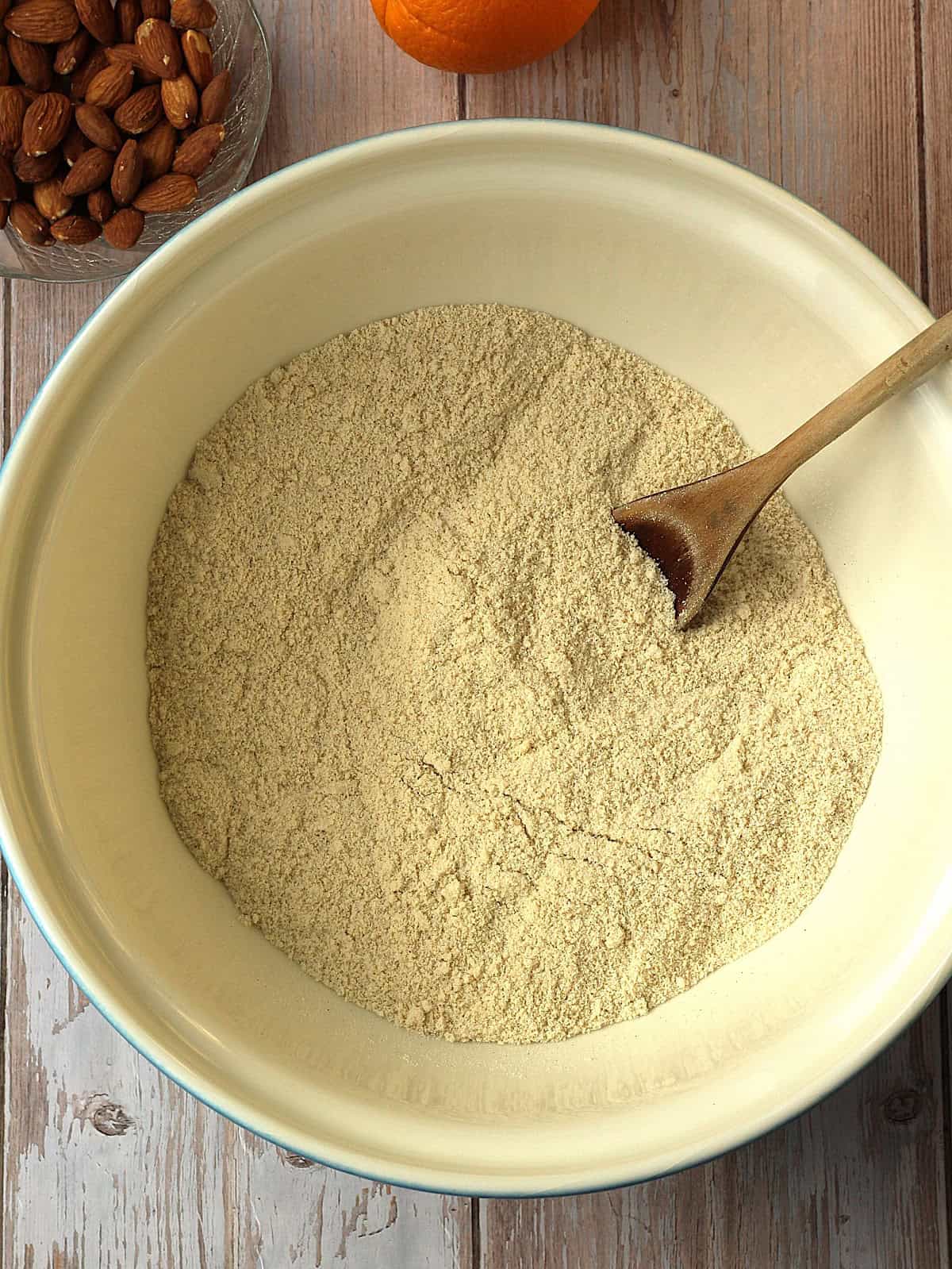 Almond flour, flour and sugar stirred in bowl for quaresimali cookies.