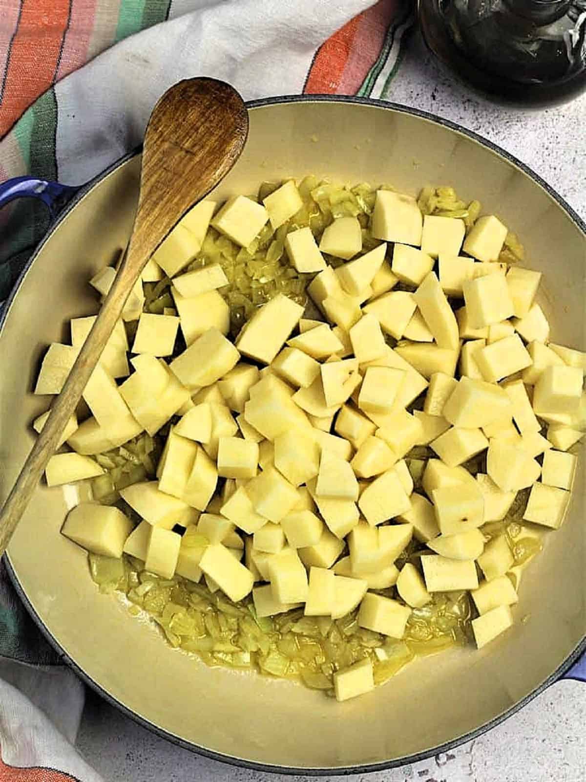 Diced potatoes and onions in pan for pasta e patate recipe.