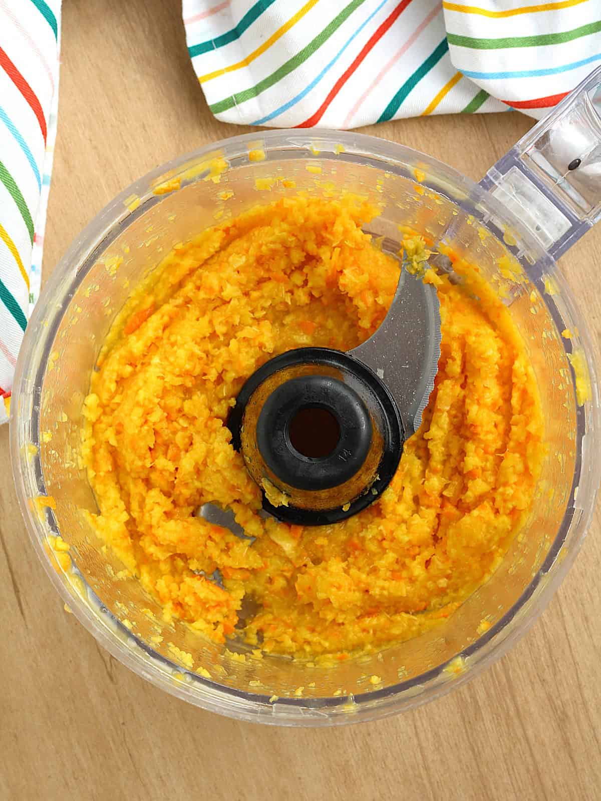 Whole orange puréed in food processor bowl for orange cake.