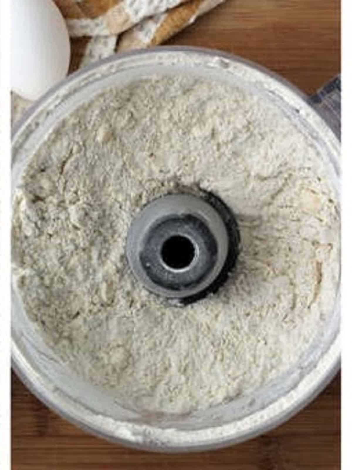 Butter combined with flour in food processor bowl for ricotta pie dough.