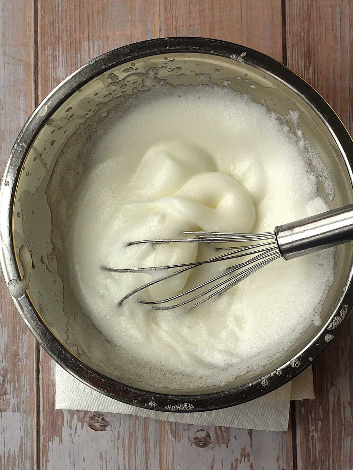 Whisked egg whites with sugar for quaresimali cookie dough.