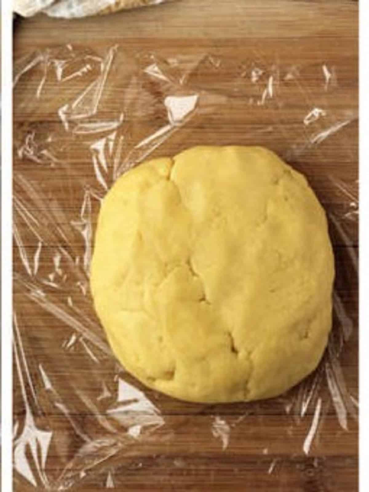 Ricotta pie dough shaped into disc.