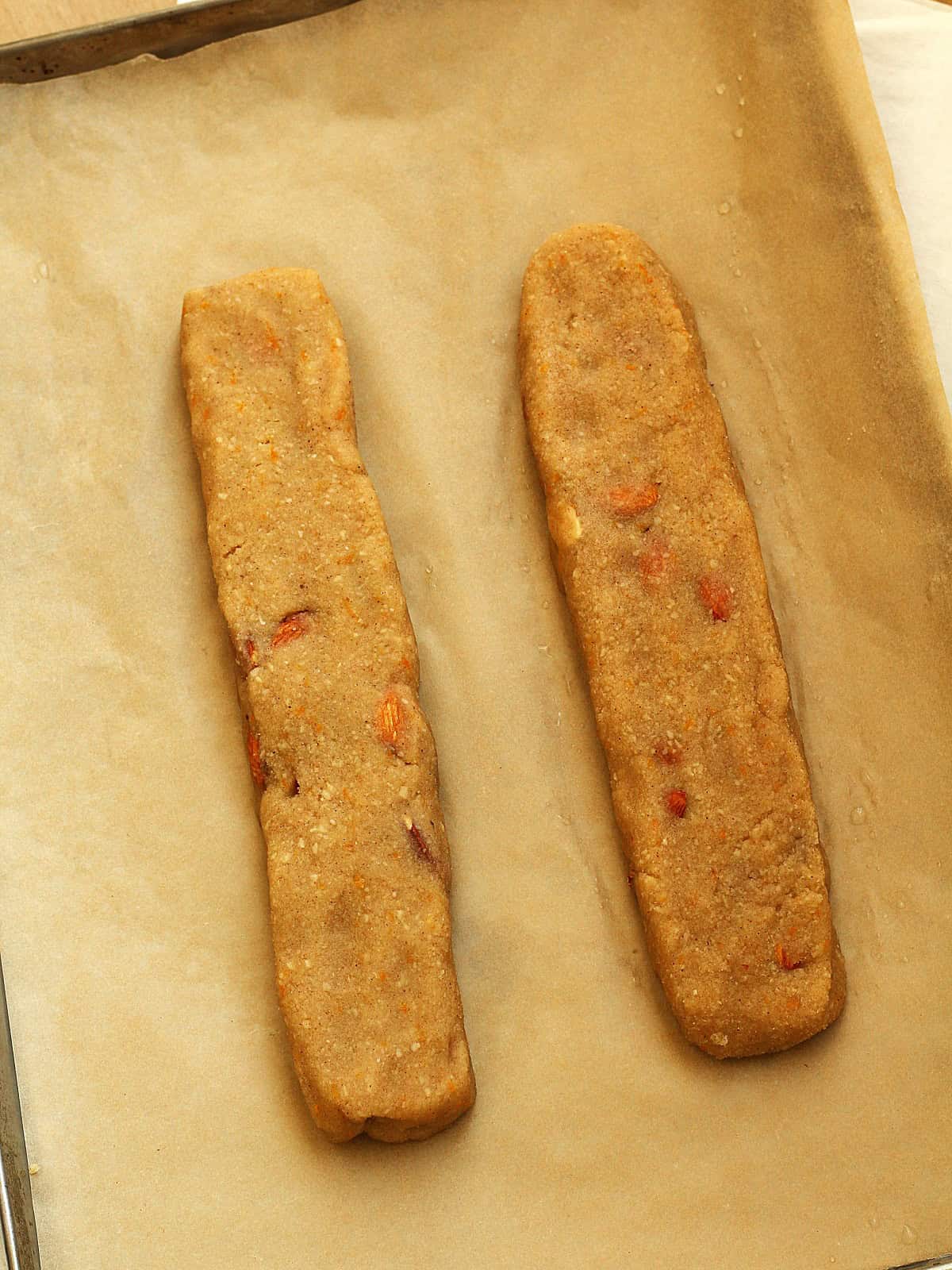 Loaves of almond lenten cookies on baking sheet.