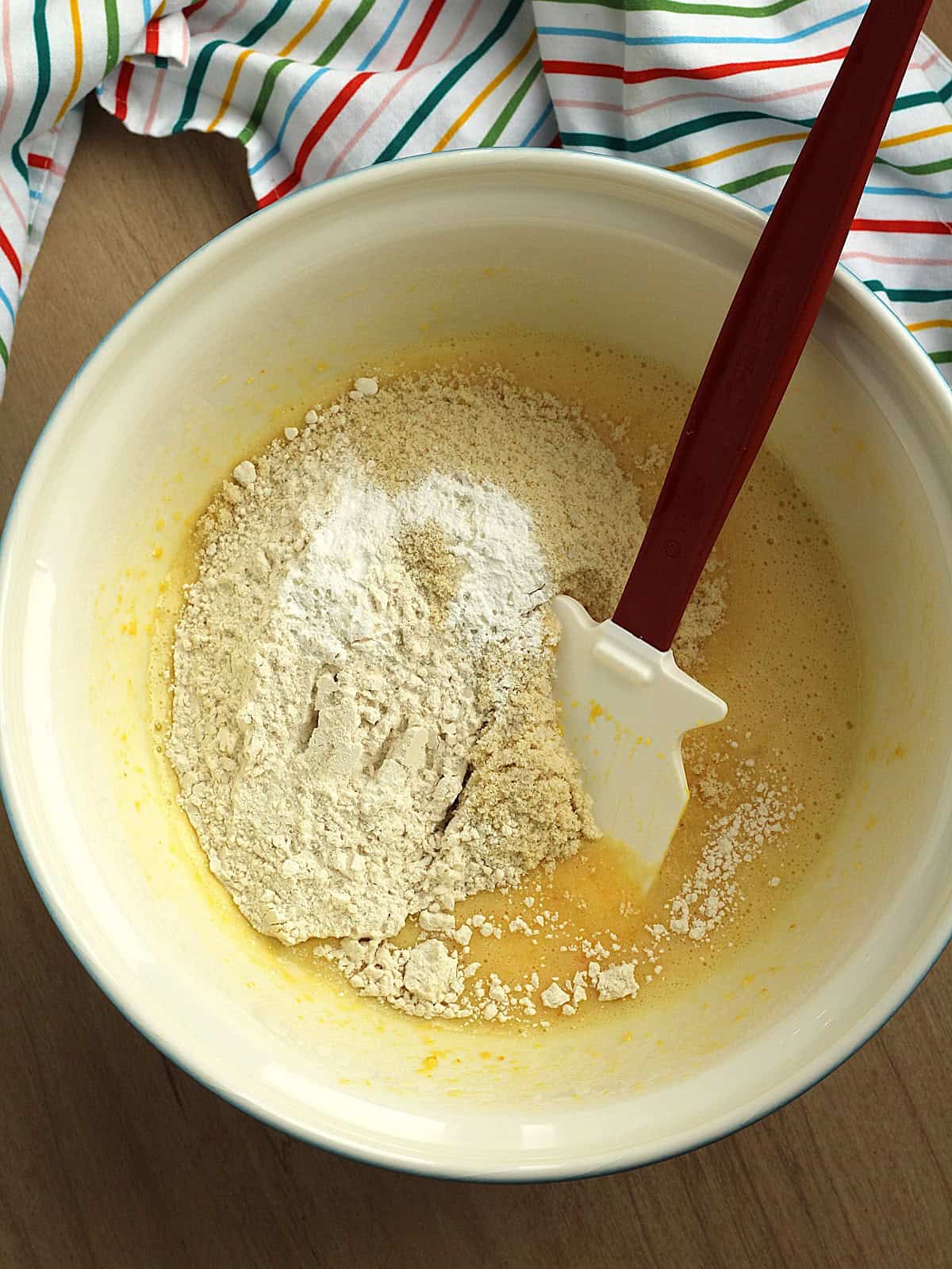 Dry ingredients added to bowl with puréed orange for whole orange cake.