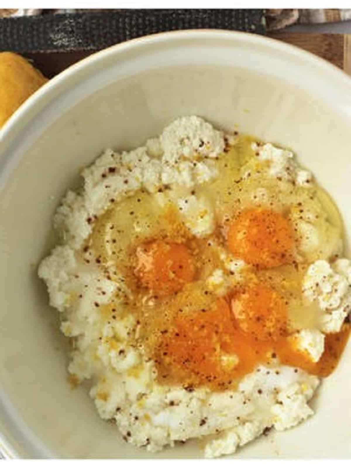 Ricotta mixed with eggs, cinnamon and sugar for ricotta pie filling.