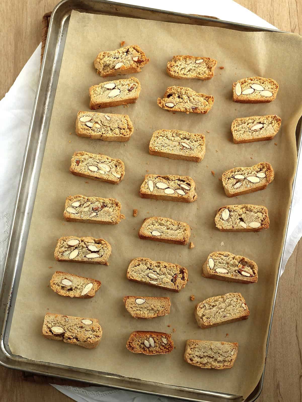 Sicilian lenten cookies with almonds cut into indivudual biscotti and placed on baking sheet. 