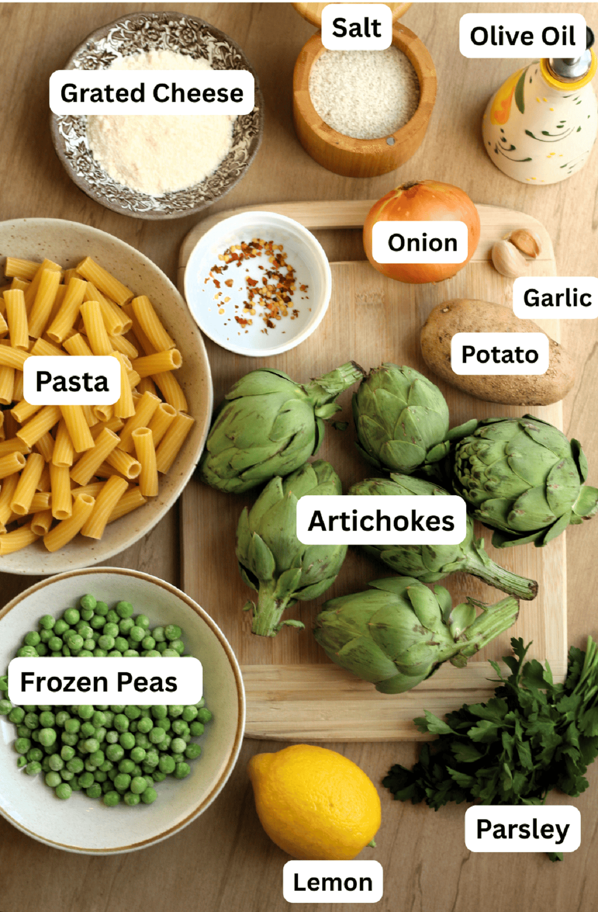 Artichokes, peas, potato, pasta, oil,  salt, pepper, lemon, parsley and grated cheese for artichoke pasta recipe.