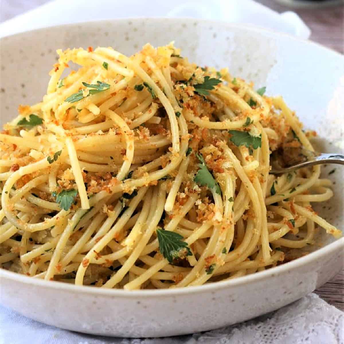 Sicilian pasta with anchovies and muddica in bowl.