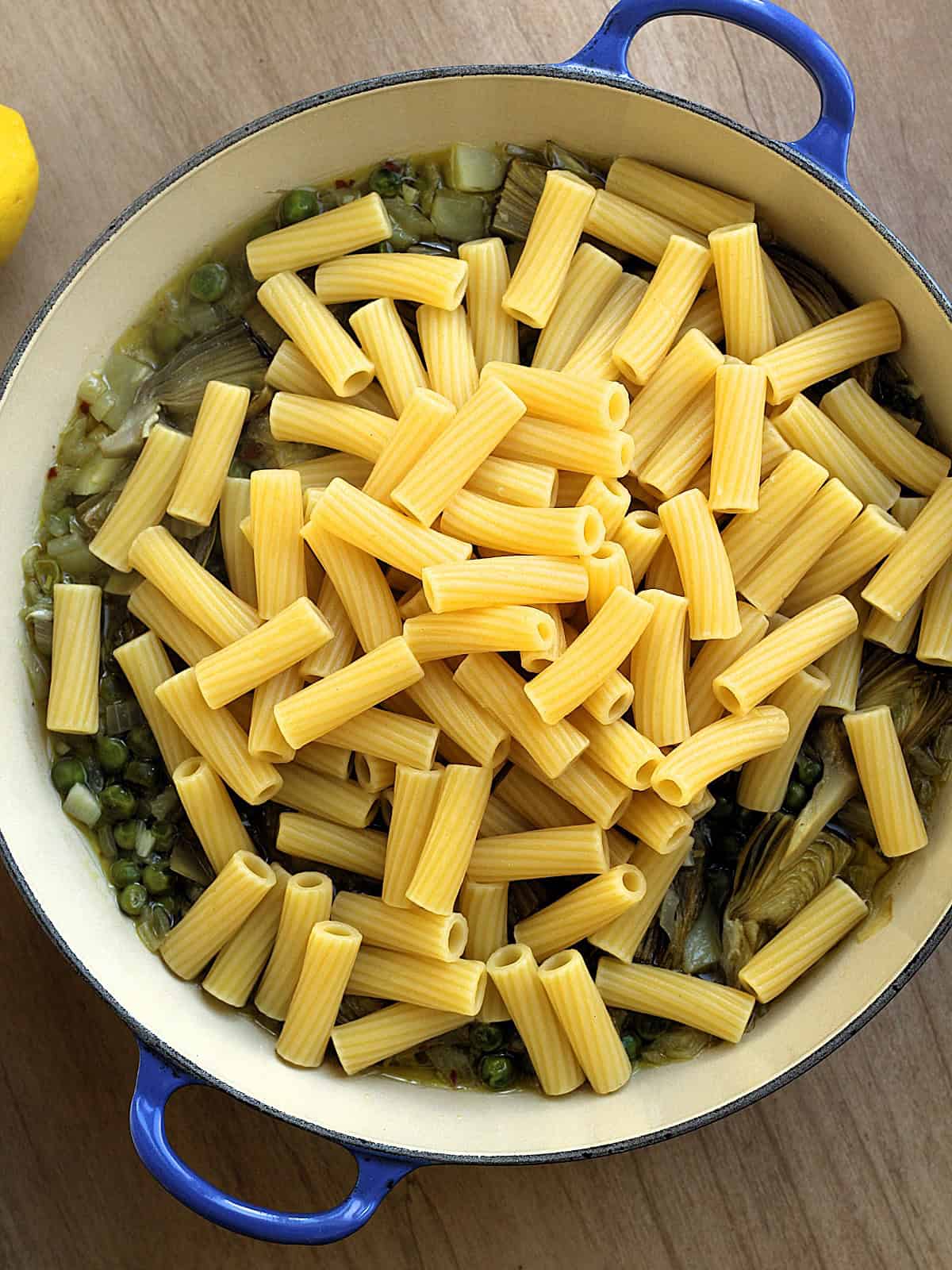 Drained pasta added to skillet with artichokes, peas and potatoes.