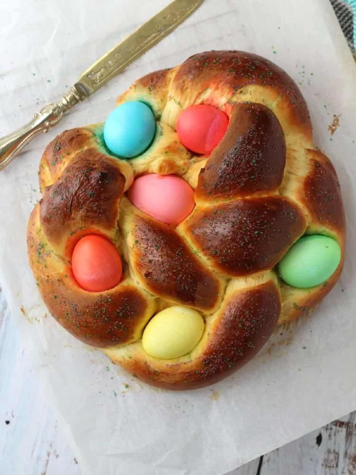 Baked braided Easter bread with colored eggs.