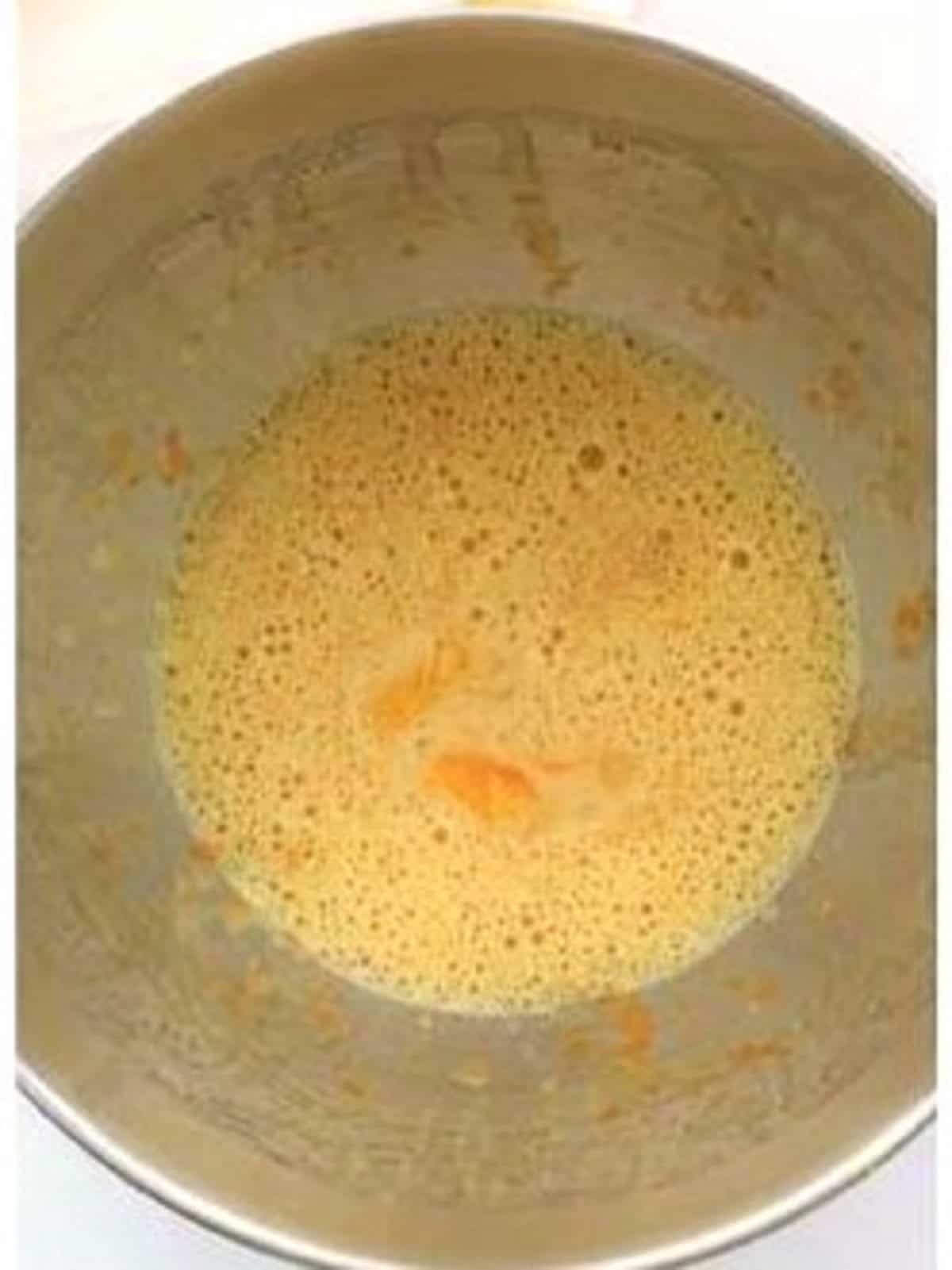 Orange zest and vanilla stirred into brioche dough mixture in food processor bowl.
