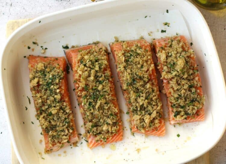 Breadcrumb toppped salmon fillets in baking dish.