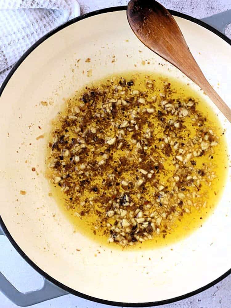 Melt anchovies in olive oil with the back of a spoon in the skillet.