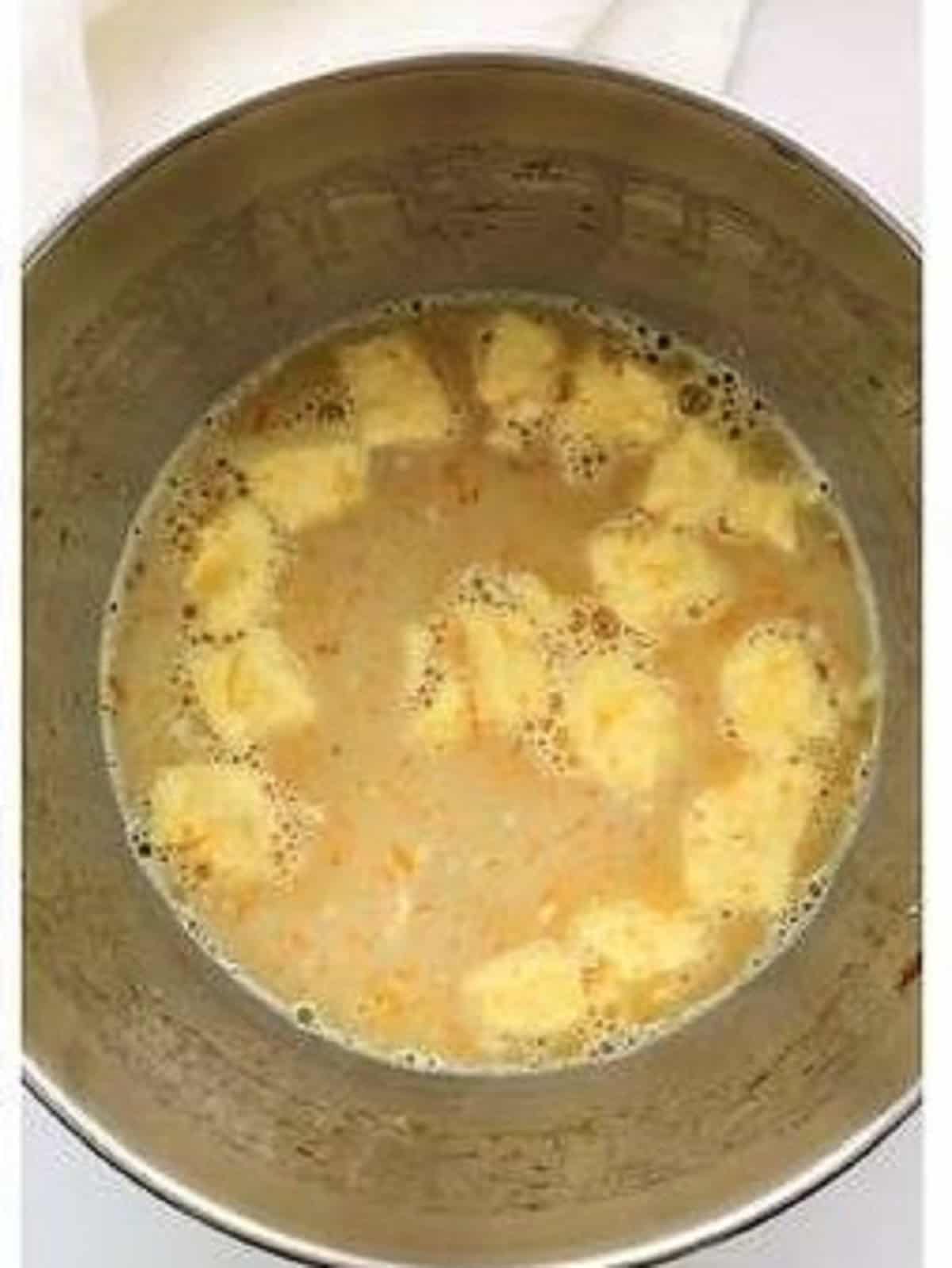 Cubed butter added to mixture in food processor bowl for Easter bread recipe.