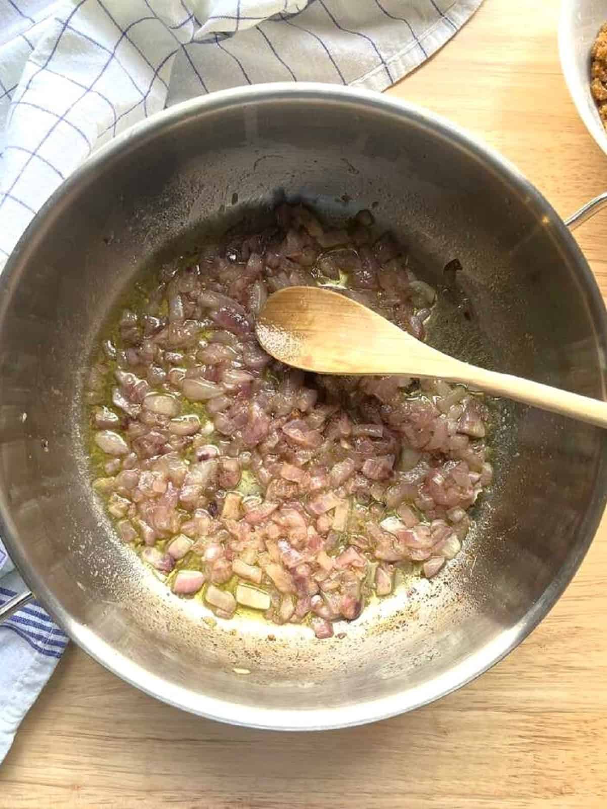 Anchovies melted in skillet with onions for anchovy and wild fennel pasta recipe.