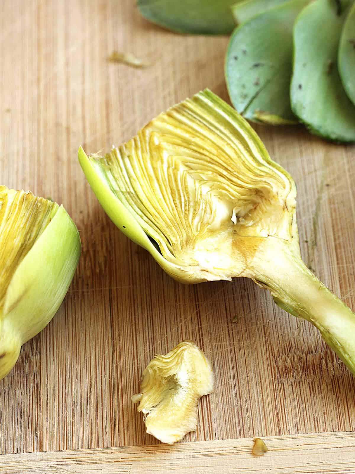 Fuzzy choke removed from the center of a halved artichoke.