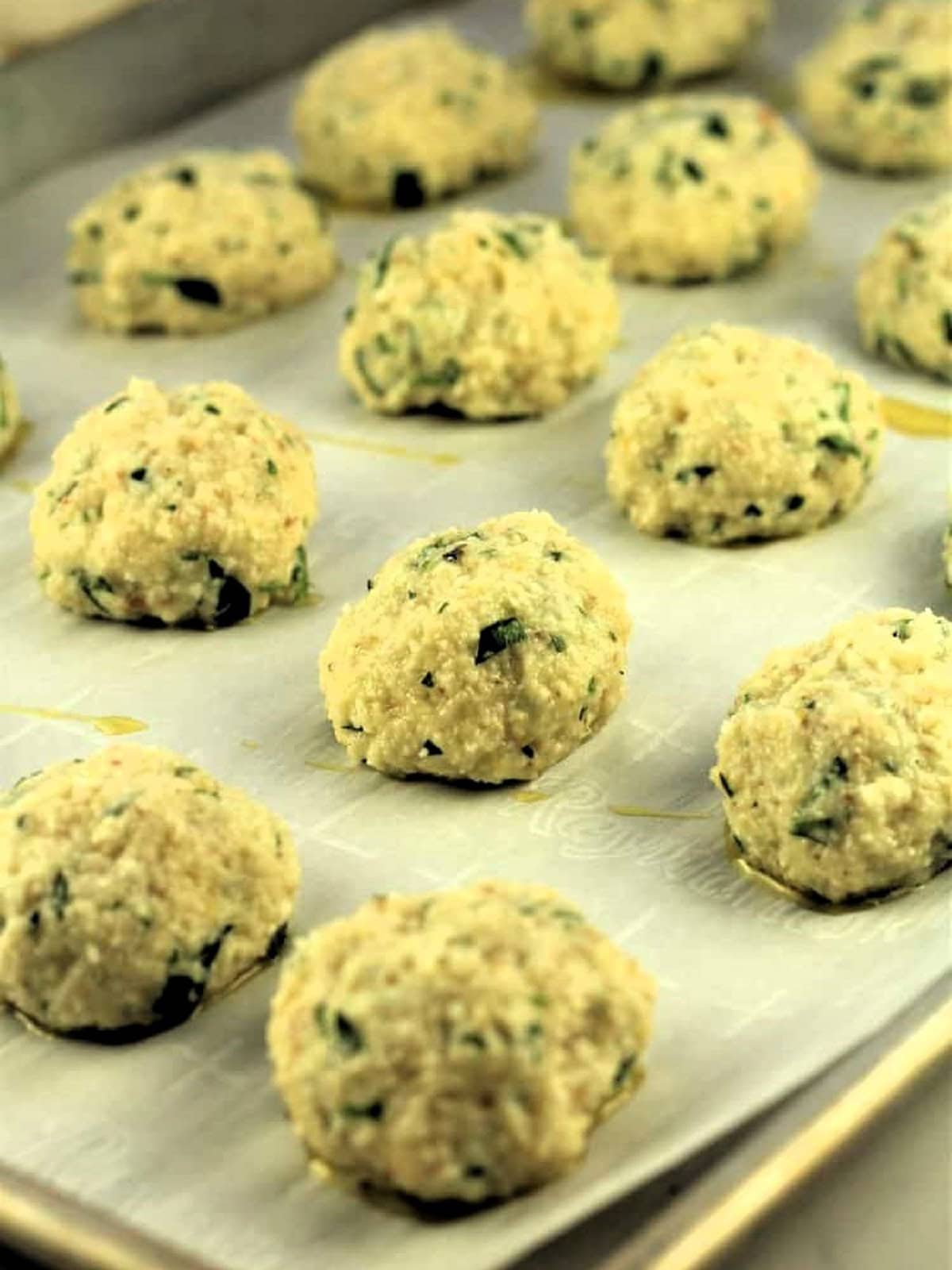 Meatless meatballs on baking sheet ready to be baked.